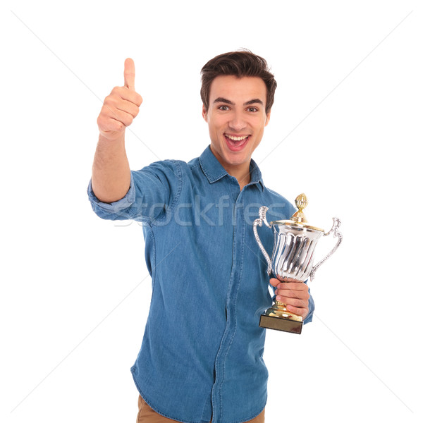 Meglepett férfi tart trófea csésze ok Stock fotó © feedough
