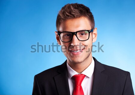 üzletember szemüveg mosolyog portré fiatal kamera Stock fotó © feedough