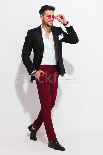 handsome smart casual man stepping to side and arranging sunglas Stock photo © feedough