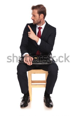 man in tuxedo looking down while sitting on a stool, Stock photo © feedough