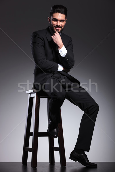  business man sitting while petting his beard. Stock photo © feedough