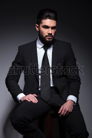 angry young business man in classic suit and tie sitting Stock photo © feedough