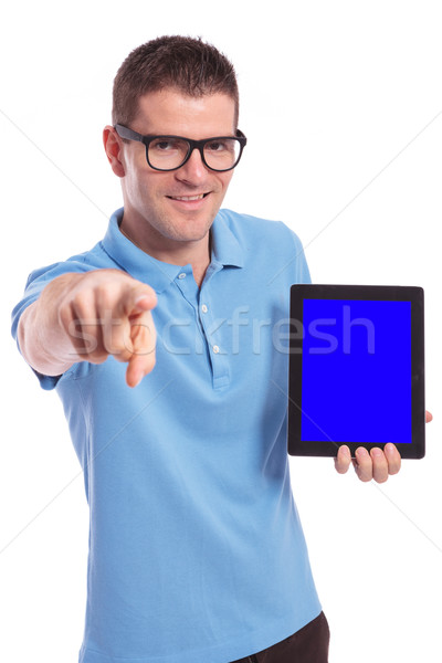 casual man presents tablet and points at you Stock photo © feedough
