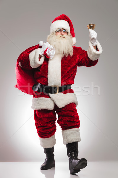 santa claus holding presents bag on shoulder and rings bell Stock photo © feedough