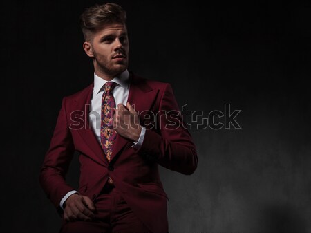 surprised young man in grena suit looks to side Stock photo © feedough