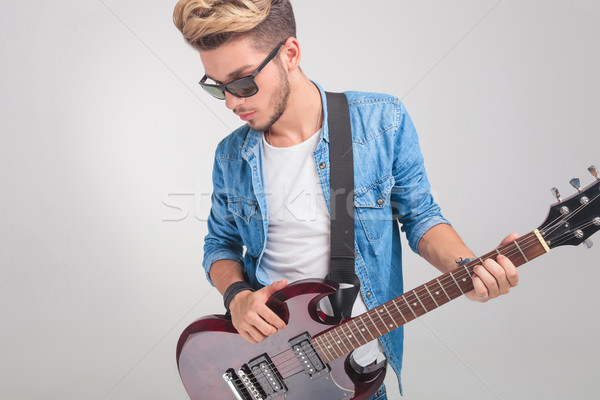 blonde man in studio wearing glasses while holding a guitar Stock photo © feedough