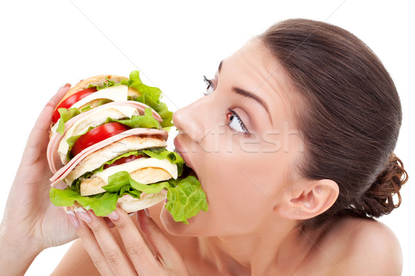 Young woman biting into a bread roll Stock photo © feedough