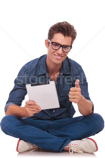 man sitting with pad shows ok Stock photo © feedough