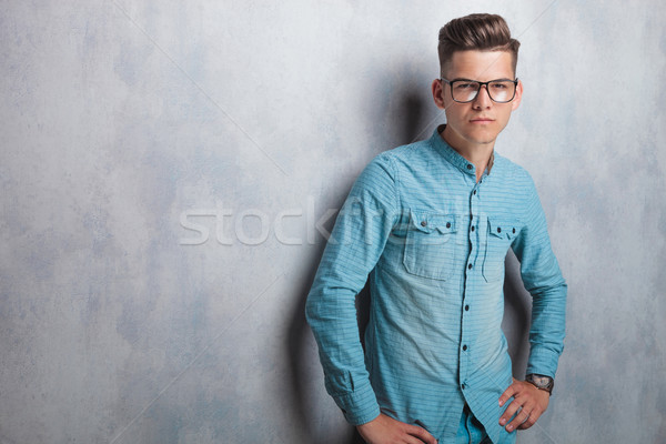 Stock photo: Young man wearing a blue shirt and glasses 