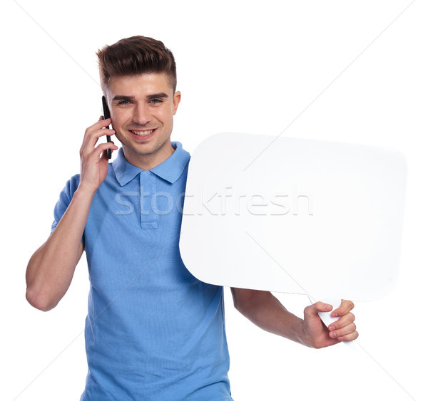 man talks on the phone and holds a speech bubble Stock photo © feedough