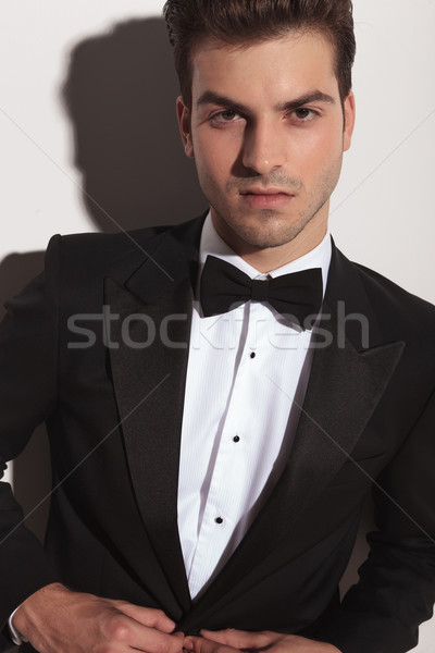  elegant young man unbuttoning his jacket Stock photo © feedough