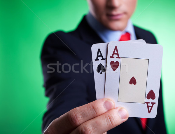 business man holding a pair of aces Stock photo © feedough