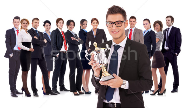 businss man holding a trophy in fron of his team Stock photo © feedough