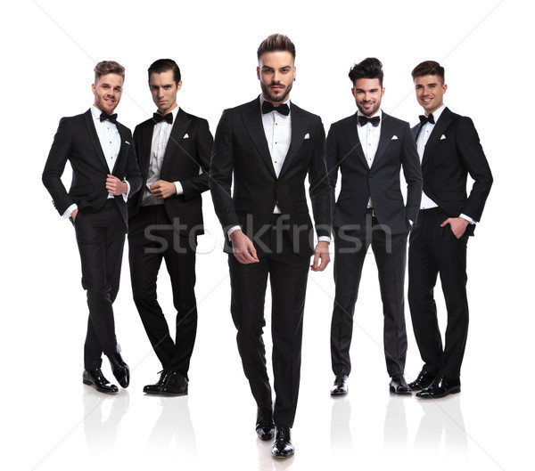 elegant young groom walks in front of his group Stock photo © feedough