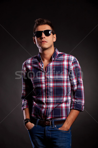 young man standing with both hands in pockets Stock photo © feedough