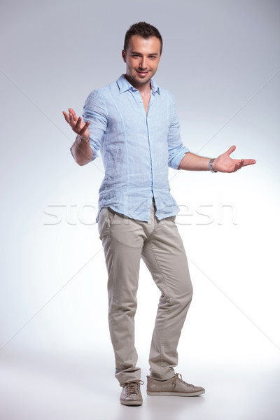 casual man welcoming with hands opened Stock photo © feedough