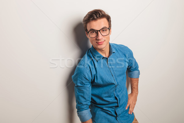 relaxed casual man with hand on waist leaning on  wall  Stock photo © feedough