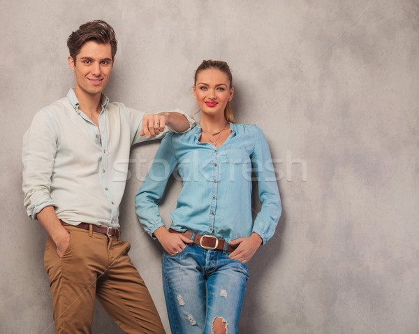 man lean on his girl shoulder while she poses with hands in pock Stock photo © feedough