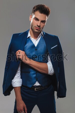 Stock photo: seated young business man looks at you