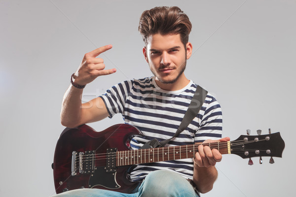 guitarist seated in studio with guitar on lap Stock photo © feedough