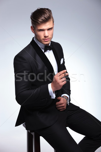 Stock photo: business man sits on chair with cigarette in hand