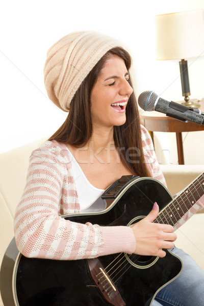 girl with a guitar singing on microphone Stock photo © feelphotoart