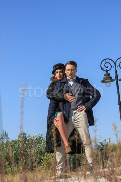 Fashionable vintage couple standing outside in romantic style Stock photo © feelphotoart