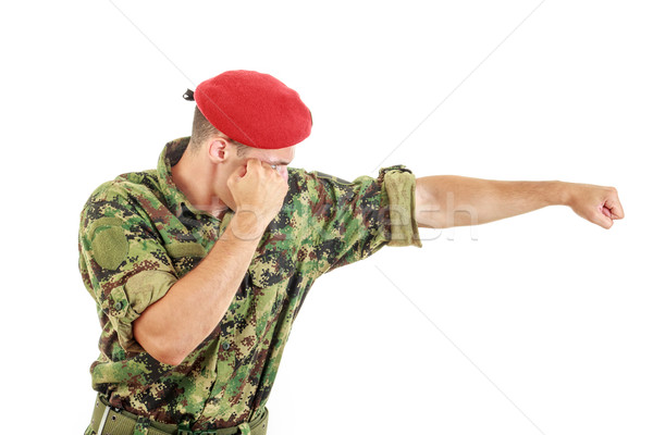 Soldier in military uniform and cap hitting with fist Stock photo © feelphotoart