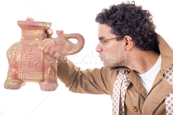 Stock photo: somber professor in coat with glasses looking old artifact