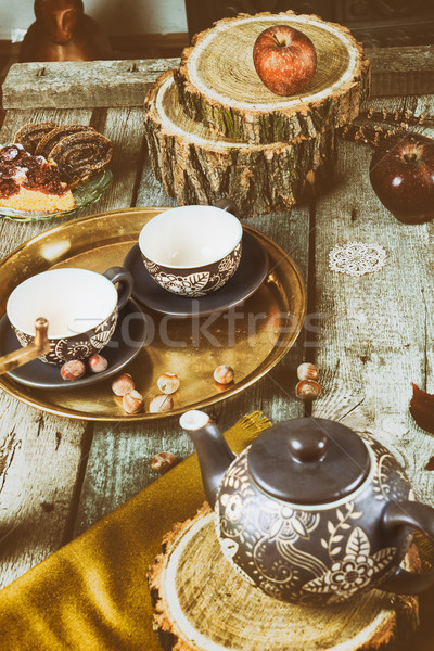 Tea cups with teapot on traditional vintage wooden table Stock photo © feelphotoart