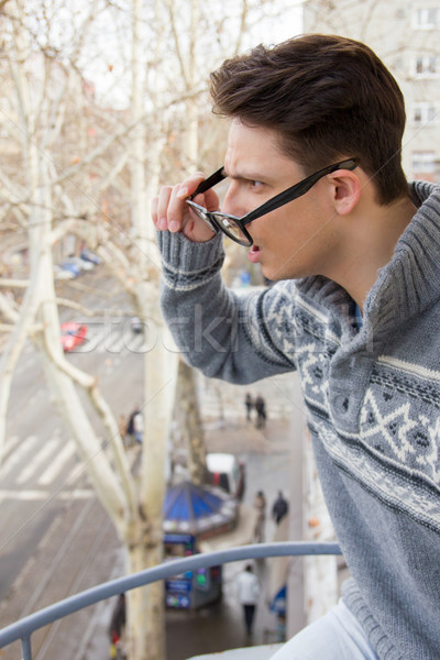 surprised man with glasses and cup of coffee in his hand standin Stock photo © feelphotoart