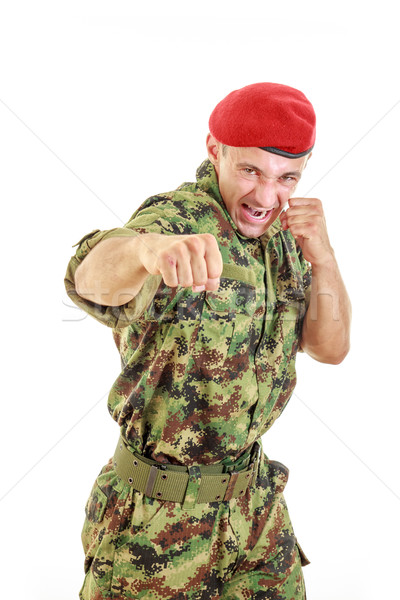 Angry military soldier in uniform and cap hitting with fist Stock photo © feelphotoart