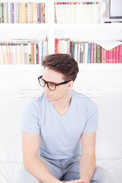 man with glasses sitting on a couch Stock photo © feelphotoart