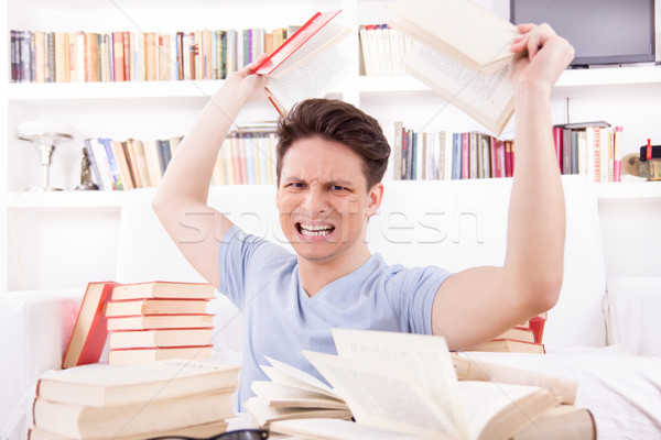 angry student  surrounded by books  throws books Stock photo © feelphotoart