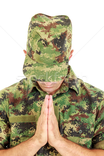 War soldier praying in military camouflage uniform with head bow Stock photo © feelphotoart