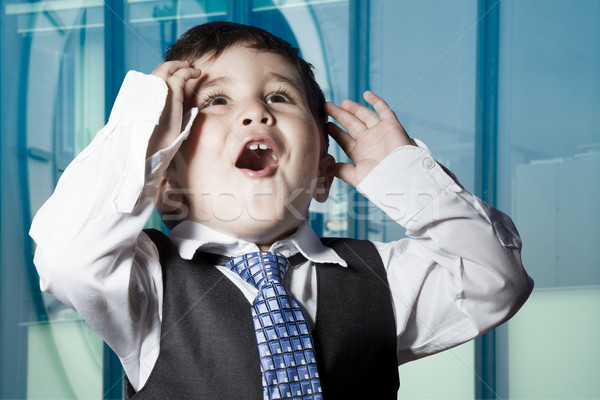 Stock photo: Child dressed businessman with funny face. surprise