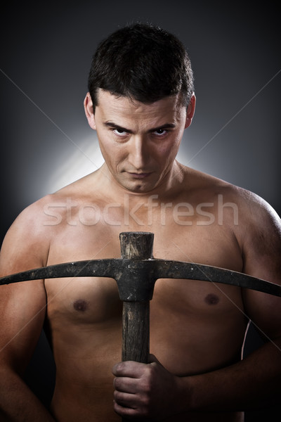 Topless man worker with pick axe  over grey background Stock photo © Fernando_Cortes