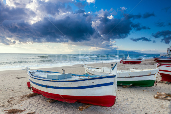 Stock photo: Boat on the beach at sunset time