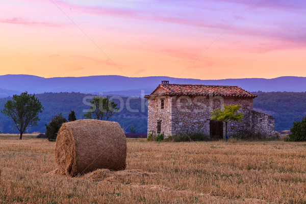 Sunset over farm field with hay bales near Sault Stock photo © Fesus