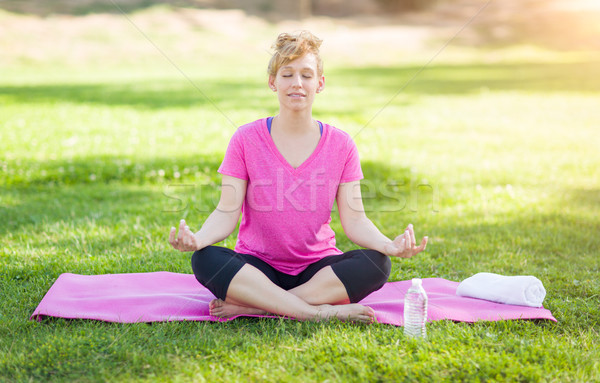 Young Fit Adult Woman Outdoors on The Grass Doing the Yoga Lotus Stock photo © feverpitch