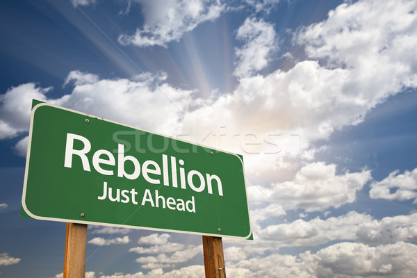 Stock photo: Rebellion Green Road Sign and Clouds