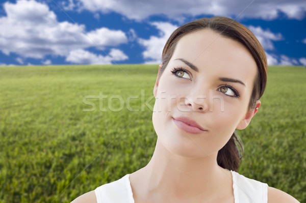 Contemplative Woman in Grass Field Looking Up and Over Stock photo © feverpitch