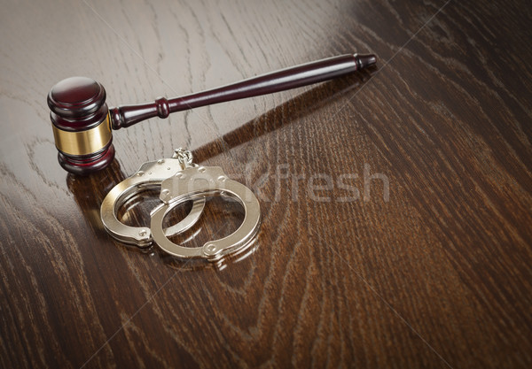 Gavel and Pair of Handcuffs on Table Stock photo © feverpitch