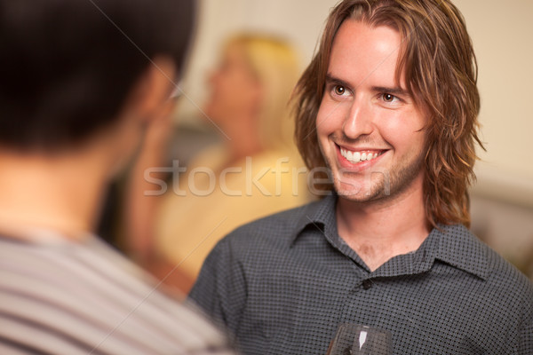 Smiling Young Man with Glass of Wine Socializing Stock photo © feverpitch