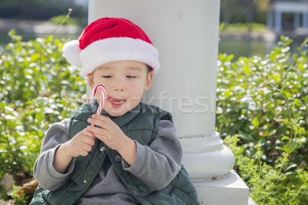 Cute Mixed Race Boy With Santa Hat and Candy Cane Stock photo © feverpitch