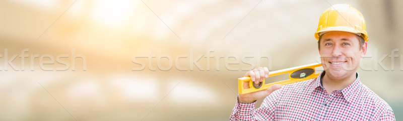 Handsome Adult Male Contractor Holding Level with Room For Text. Stock photo © feverpitch