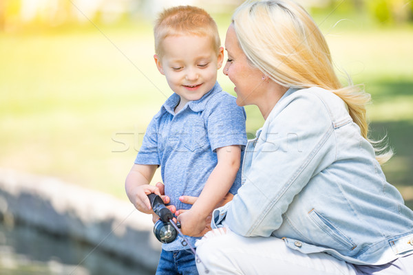 Young Caucasian Mother and Son Having Fun Fishing At The Lake Stock photo © feverpitch