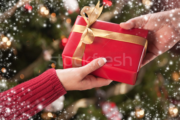 Stock photo: Man and Woman Gift Exchange with Snow Flakes Border
