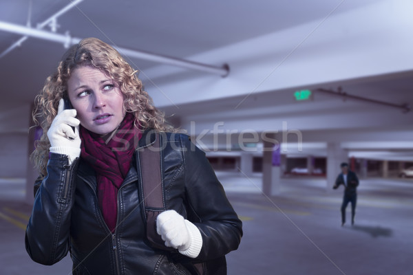 Frightened Young Woman On Cell Phone in Parking Structure Stock photo © feverpitch