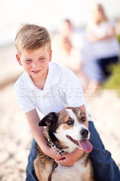 Stock fotó: Jóképű · fiatal · srác · játszik · kutya · tengerpart · boldog